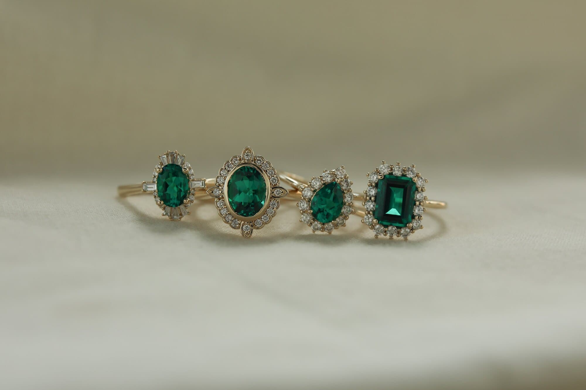 group shot of emerald engagement rings