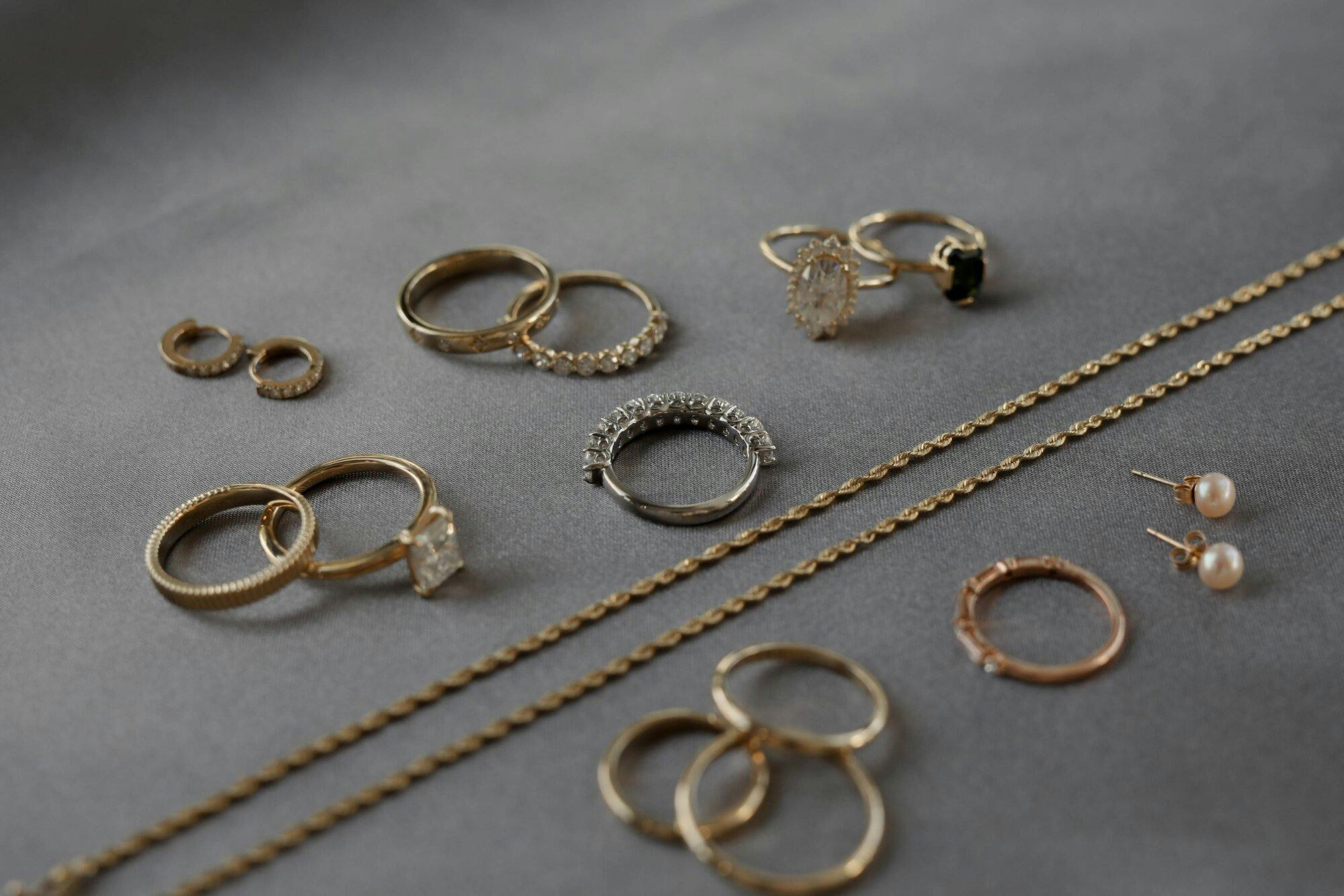 a group shot of different jewelry pieces on grey fabric