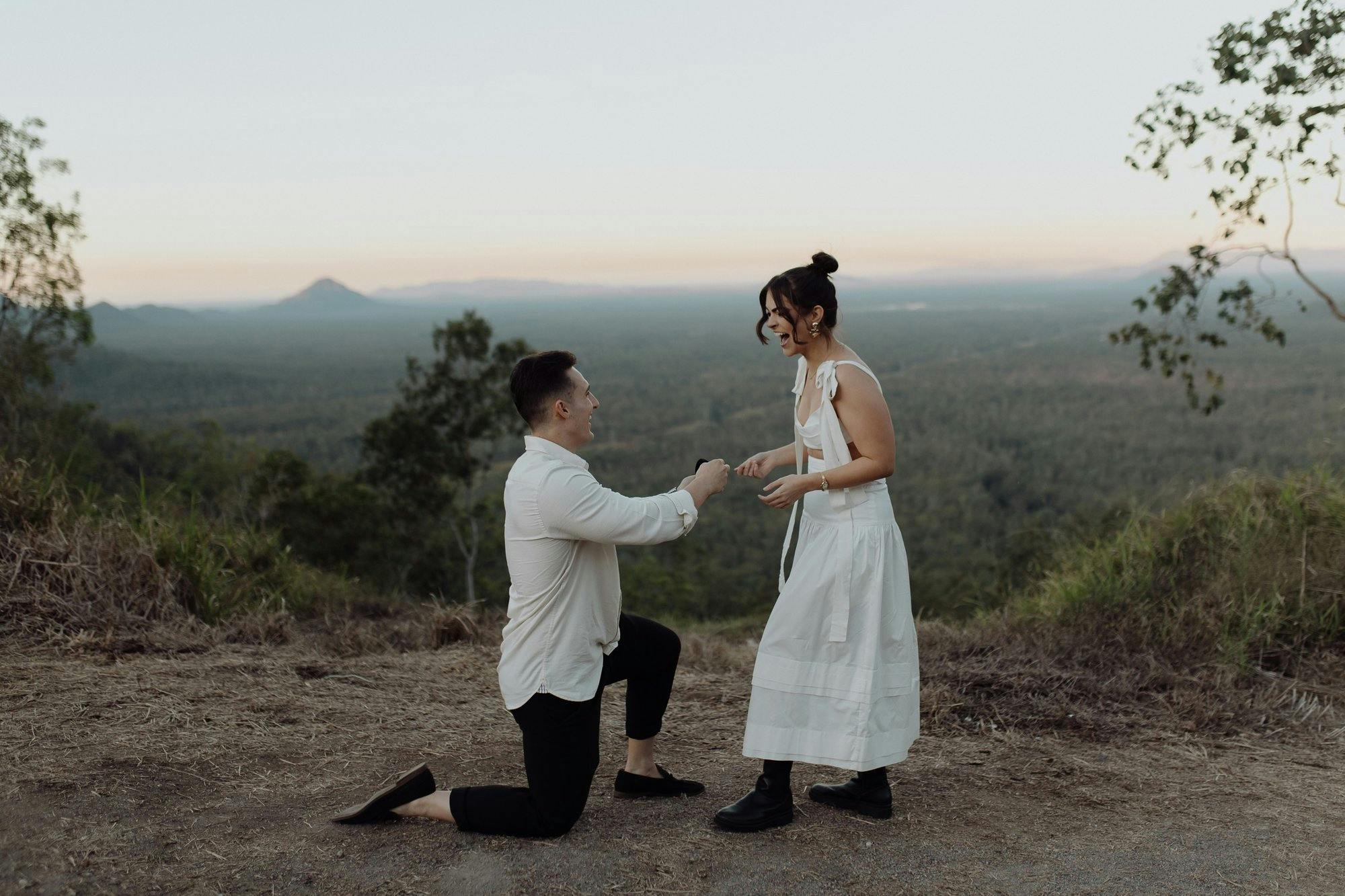 a couple getting engaged on a mountain